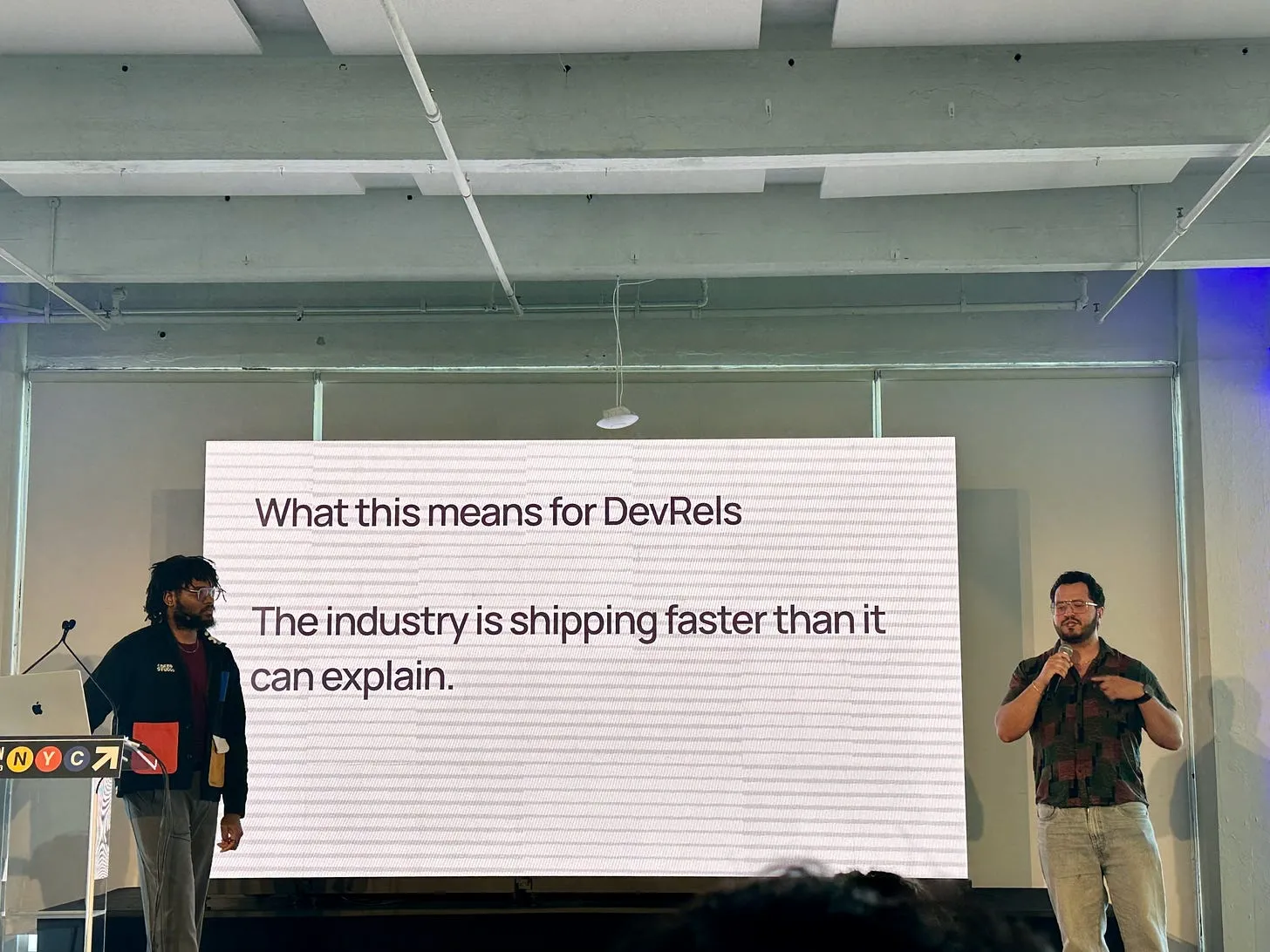 Juan Pablo Flores Cortés and Clement Hugbo presenting on stage at DevRelCon New York 2026.