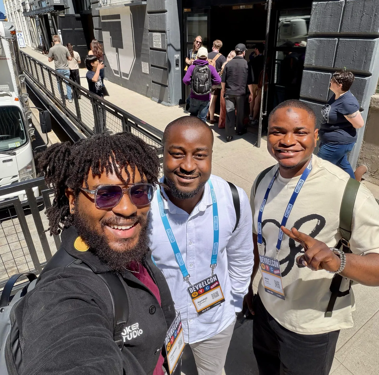 Clement, Ayodeji, and Idris smiling together outside the DevRelCon NYC 2026 venue.